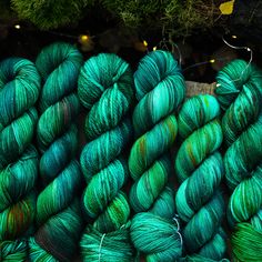 several skeins of green yarn sitting next to each other