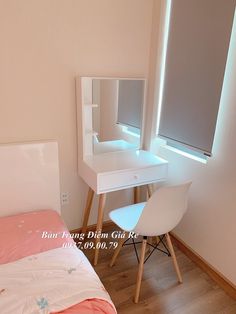 a bedroom with a bed, desk and mirror on the wall next to each other