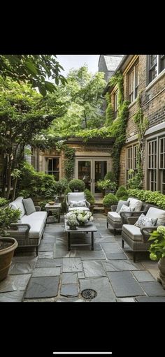 an outdoor living area with couches and tables