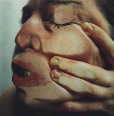 a woman with her hands on her face