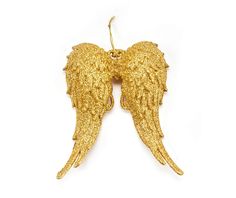 two gold angel wings hanging from a hook