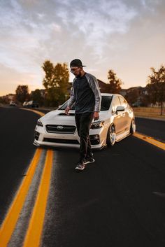 a man standing next to a white car