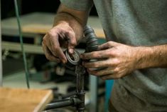 a man is working on an object in his workshop