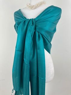 "This is an all season shawl. This versatile shawl can be used to dress up an outfit for a special evening, a wedding or as a neck scarf in the winter. Easy to carry anywhere, perfect for when you need it at a restaurant or at the office in air conditioning or a cool summer evening. Effortlessly give a dress a new look by simply adding this shawl. A must have when you travel! COLOR MATCHING/ACURACY The color is very close however is not exact, I tried to to capture the colour as acurately as possible but was not able to get the exact colour under any lighting.  In the pictures I have posted sometimes one picture looks like its a slighty different shade than others, please mention the specific color/picture you are interested in when you place the order, if the shade matters. If you are try Green Pashmina Shawl For Wedding, Green Silk Pashmina Shawl, Elegant Green Pashmina Shawl, Green Silk Shawl For Wedding, Elegant Green Pashmina Shawl For Weddings, Green Silk Scarves For Formal Occasions, Formal Green Silk Scarves, Elegant Green Silk Dupatta, Green Pashmina Shawl Scarf