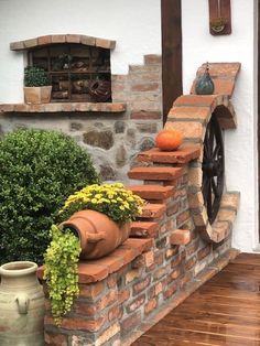 a brick wall with pots and plants on it