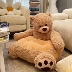 a large teddy bear sitting on top of a chair