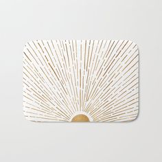 a white and gold sunburst bath mat