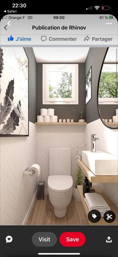 the bathroom is decorated in white and grey colors with pictures on the wall above the toilet