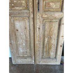 two old wooden doors with peeling paint on them