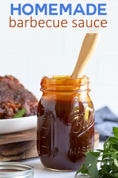 homemade barbecue sauce in a mason jar with a wooden spoon and parsley on the side