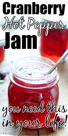 a jar filled with cranberry hot pepper jam on top of a wooden table