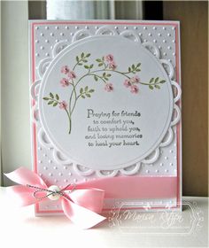 a pink and white card with flowers on it