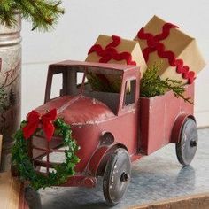 an old red truck with presents in the back