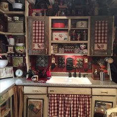 a kitchen filled with lots of cupboards and dishes on top of a counter next to a sink