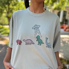 Dino graphic on a garment dye oversized t-shirt. Fabric: 100% Cotton C137 Seafoam Color, Curvy Jeans, Capri Blue, Curvy Dress, Shirt Fabric, Hats For Sale, Oversized T Shirt, Quality Fashion, Oversized Tshirt