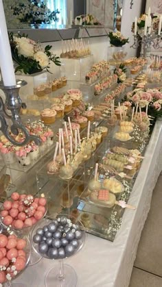 a table filled with lots of desserts and cupcakes on top of it