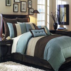 a bed with blue and brown comforters in a bedroom