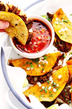 a plate full of tacos and tortilla chips