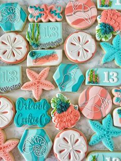 decorated cookies are arranged on a table with numbers and seashells in the background