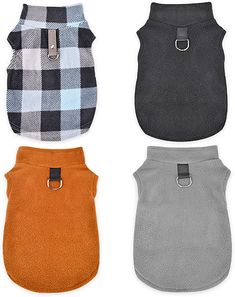 four dog vests in different colors and patterns, one with a buckle on the front