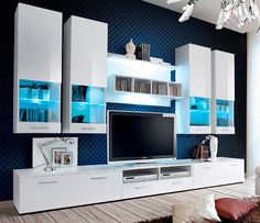 a living room with white furniture and blue walls