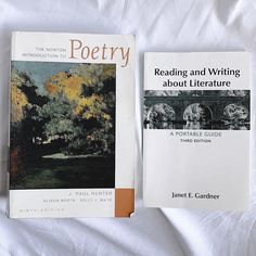 two books sitting on top of a white bed next to each other in front of a white sheet