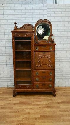 an old wooden dresser with a clock on top