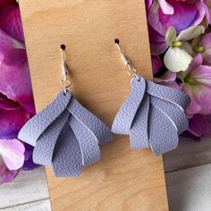 the earrings are made out of leather and have leaves on them