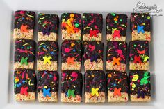 rice krispy treats are decorated with colorful sprinkles and black icing