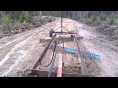 an aerial view of a construction site in the middle of a forest with equipment on it