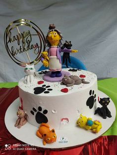 a birthday cake decorated with cats and dogs