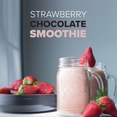 strawberry chocolate smoothie in a mason jar with fresh strawberries on the side and another bowl full of strawberries behind it