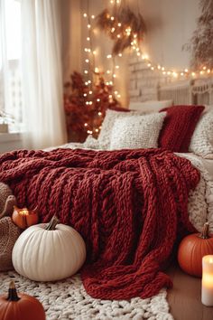 A cozy bedroom with a deep red chunky knit blanket draped over the bed. Fall Bedroom Decor, Cozy Fall Bedroom, Fall Bedding, Apartment Makeover, Autumn Decorating, Christmas Decorations Bedroom, Bedroom Red