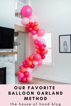 the balloon garland is hanging in front of a fireplace with pink and red balloons on it