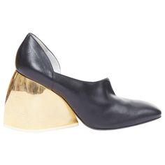 LOEWE gold curved heel black leather slip on heeled shoes EU39 Reference: ECLO/A00130 Brand: Loewe Designer: JW Anderson Collection: Runway Material: Leather, Metal Color: Black, Gold Pattern: Solid Closure: Slip On Lining: Black Leather Extra Details: Gold curved chunky heels. Made in: Italy CONDITION: Condition: Good, this item was pre-owned and is in good condition. Please refer to image gallery for thorough condition check. Multi scratches and stains on gold heels. Natural worn dents at top. SIZING Designer size: EU39 Size reference: EU39 / US9 / UK6 / JP26.5 This Loewe item is authentic. Loewe Shoes, Leather Slip Ons, Gold Heels, Metal Color, Gold Pattern, Giuseppe Zanotti, Jil Sander, Black Heels, Chunky Heels