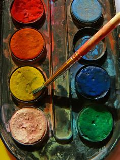 an artist's palette with several different colored paints