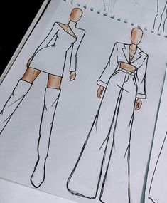 three sketches of women's clothing on paper, one in white and the other in black