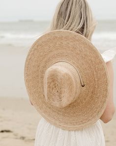 Handmade by artisans in Mexico, our new 100% raffia hats are a must-have for the warmer months. Featuring a tightly woven pressed palm design with a fedora crown, The Leon Palm Hat is the elevated essential you need for days under the sun. The wide brim and woven drawstring make this hat perfect for shade when your having a fun day at the the beach. 100% Raffia Ethically handmade in Mexico Inner elastic sweatband to help with fit Spot / specialist clean XS/S - Brim: 5 1/2" Inner Circumference: 2 Raffia Hats, Beach Hats For Women, Palm Design, Mama Bracelet, Raffia Hat, Sustainable Manufacturing, Summer Soiree, Feminine Power, Star Bracelet