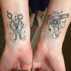 two people holding their hands with tattoos on them