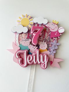 a birthday cake topper with the number seven on it and peppa pig decorations