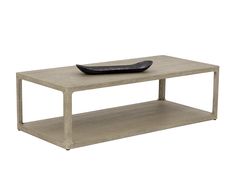 a table with a black bowl on top and a white shelf underneath the coffee table