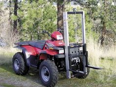 a red four wheeler parked in the grass