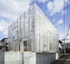 the building is covered in plastic sheeting and sits next to an empty parking lot