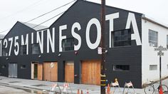 an industrial building that has been painted black and white with the word minnesota written on it