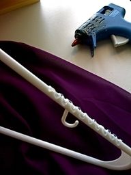 a white pipe laying on top of a purple cloth next to a blue and white blow dryer