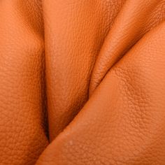 an orange leather upholster is seen in this close - up photo from above