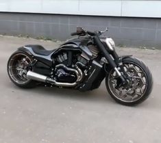 a black motorcycle parked in front of a building