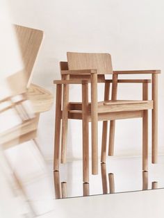 three wooden chairs sitting next to each other