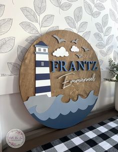 a wooden sign that says frantz with a lighthouse on it