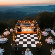 an aerial view of a wedding reception setup with checkered tablecloths and chairs